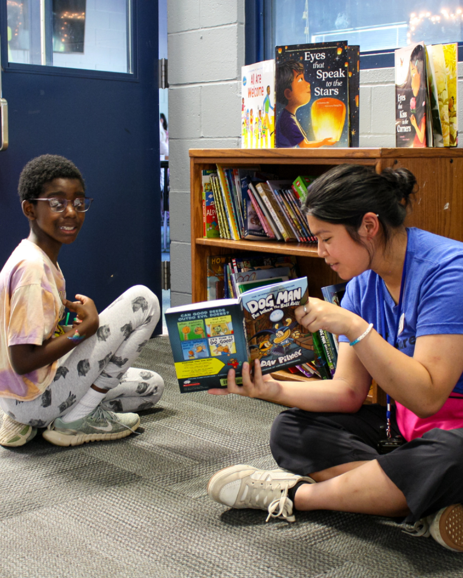 A youth development professional at the Boys & Girls Clubs of Whatcom County reads to a Club kid