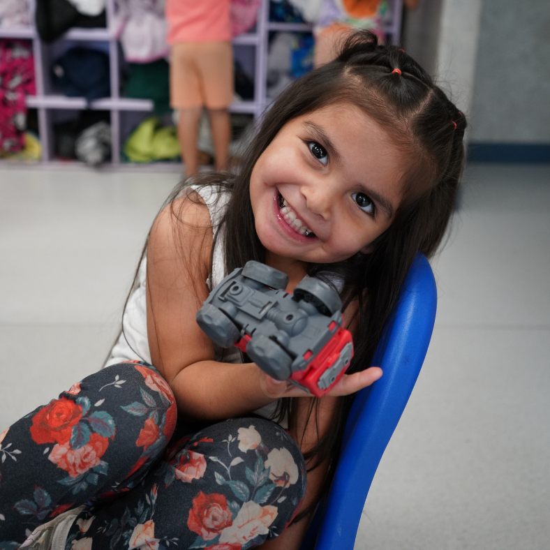 Kid holding her favorite toy